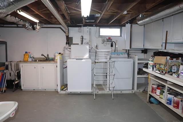 below grade area featuring a sink and separate washer and dryer