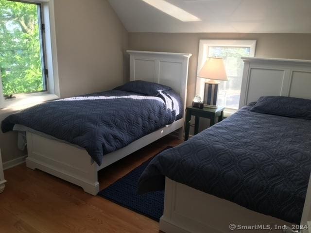 bedroom featuring vaulted ceiling and wood finished floors