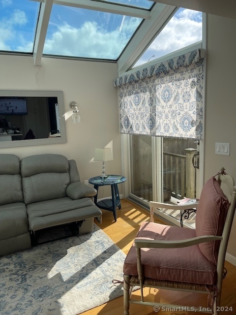 living room featuring high vaulted ceiling and light wood-type flooring