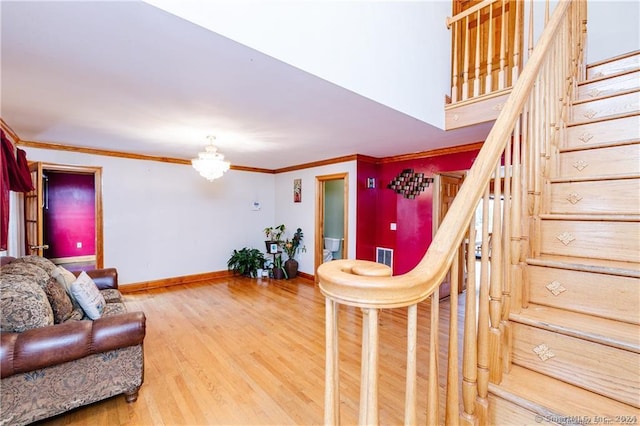 living room with crown molding and hardwood / wood-style flooring