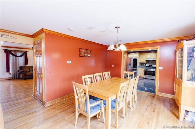 dining area featuring a notable chandelier, light hardwood / wood-style floors, and ornamental molding