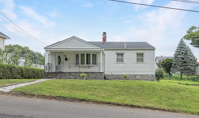 view of front of house with a front yard and covered porch