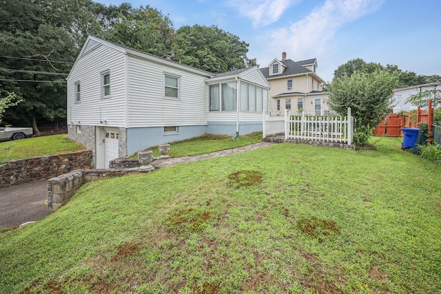 view of front of property featuring a garage and a front lawn