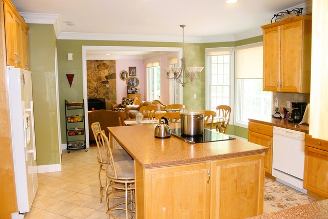 kitchen featuring pendant lighting, a chandelier, light tile patterned floors, a center island, and white appliances