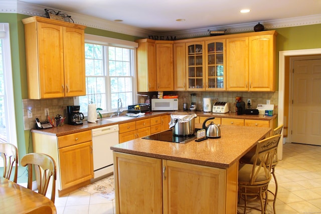 kitchen with light tile patterned floors, a center island, tasteful backsplash, and white appliances