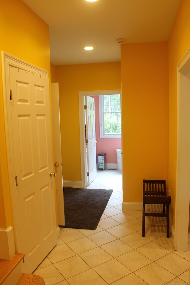 corridor with light tile patterned floors