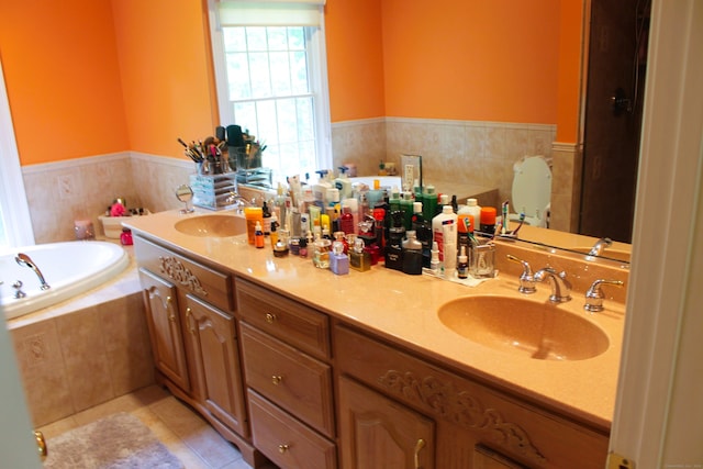 bathroom featuring tile patterned floors, double vanity, and tiled tub