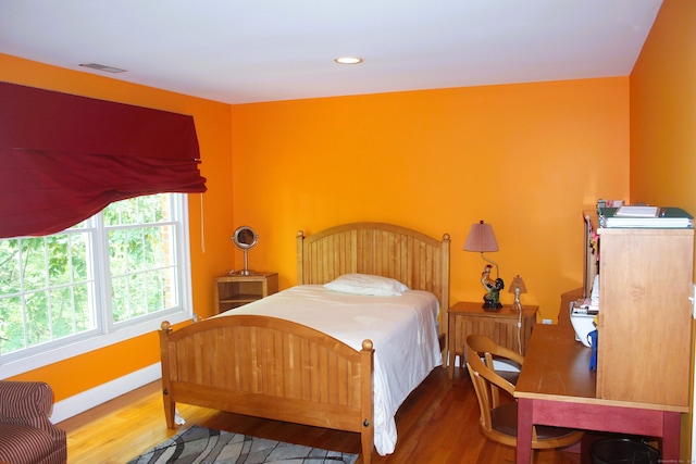 bedroom with wood-type flooring