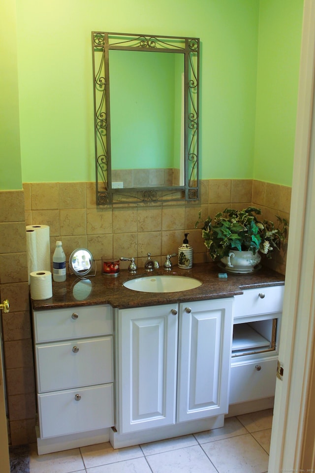 bathroom featuring tasteful backsplash, tile patterned floors, and vanity