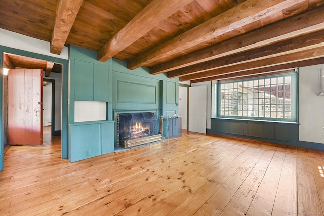 unfurnished living room featuring hardwood / wood-style flooring, wood ceiling, baseboard heating, and beam ceiling