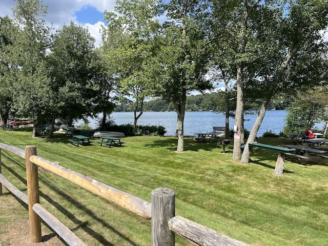 view of yard with a water view and fence