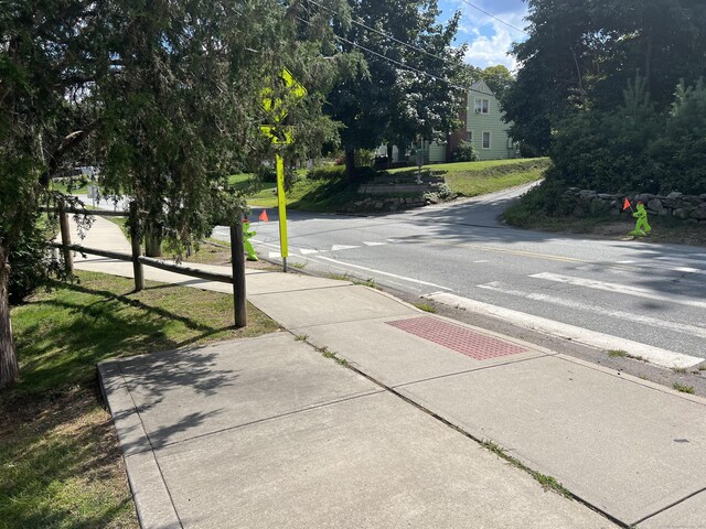 view of street with sidewalks and curbs