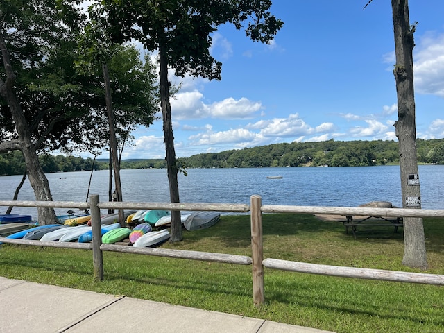 view of dock featuring a water view and a lawn