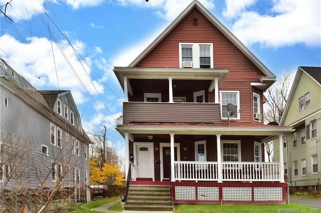 view of front of property featuring a balcony and covered porch