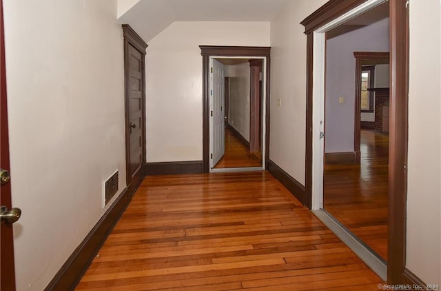 corridor with wood-type flooring