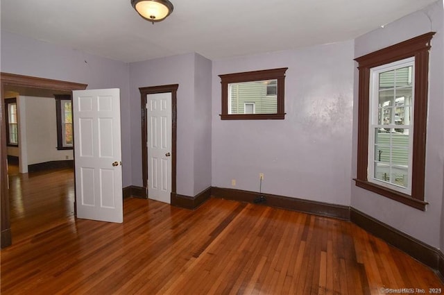 unfurnished room featuring dark hardwood / wood-style flooring