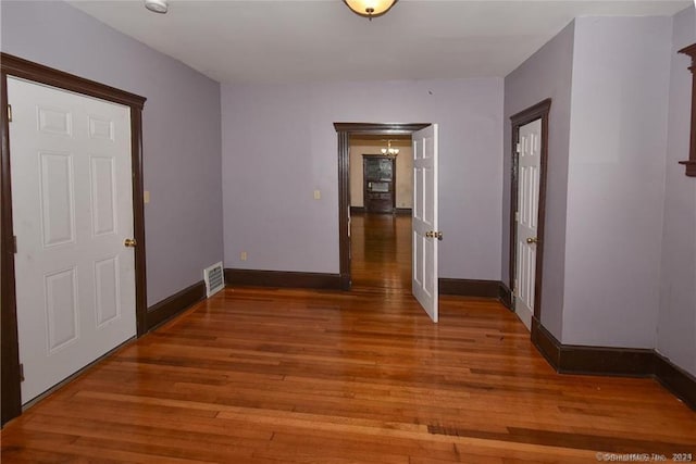 hallway with dark hardwood / wood-style flooring