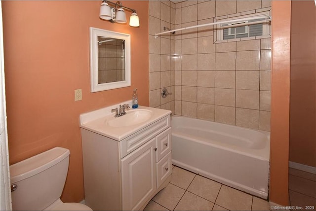 full bathroom featuring tiled shower / bath combo, vanity, toilet, and tile patterned floors