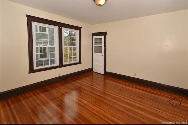 empty room with hardwood / wood-style floors