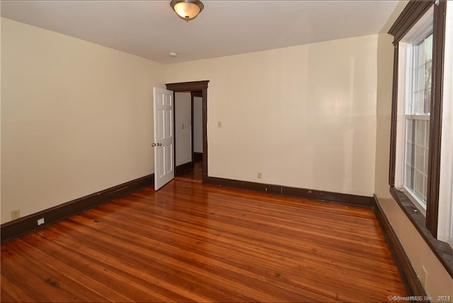 spare room with hardwood / wood-style floors