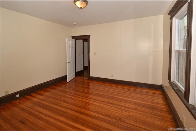 unfurnished room with dark hardwood / wood-style floors