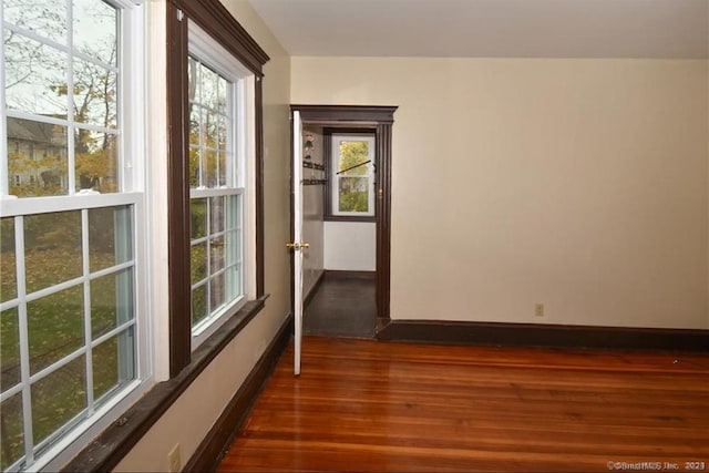 spare room with dark hardwood / wood-style floors