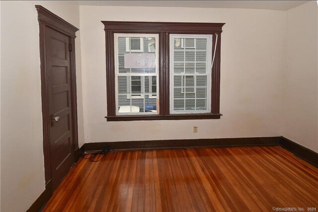 spare room with dark hardwood / wood-style flooring