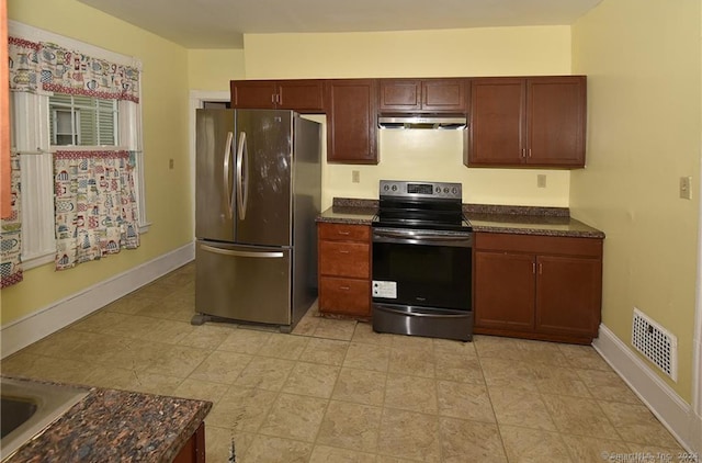 kitchen featuring light tile patterned floors and stainless steel appliances