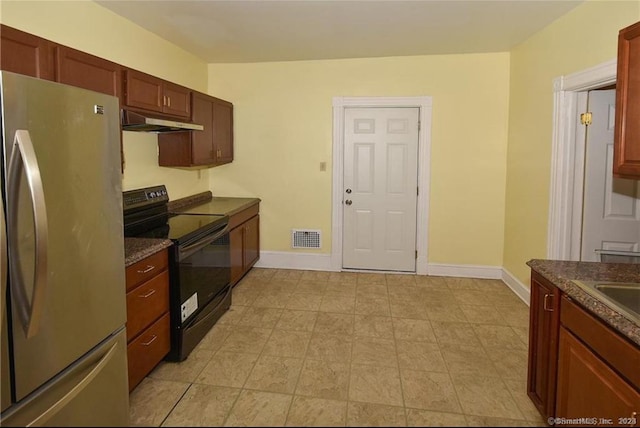 kitchen featuring black electric range and stainless steel fridge