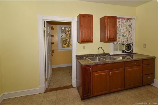 kitchen featuring dark stone countertops and sink