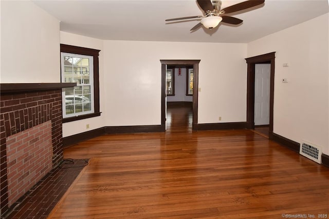 unfurnished living room with ceiling fan, hardwood / wood-style flooring, and a fireplace