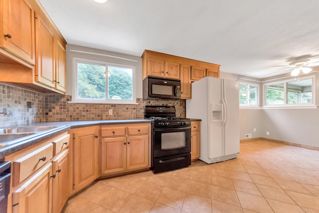 kitchen with light tile patterned flooring, sink, black appliances, ceiling fan, and backsplash