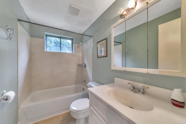 full bathroom featuring tile patterned floors, toilet, a textured ceiling, vanity, and tiled shower / bath combo