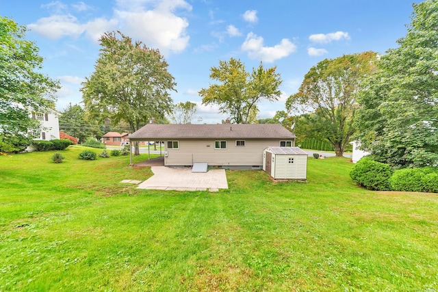 back of property with a storage shed, a patio, and a lawn