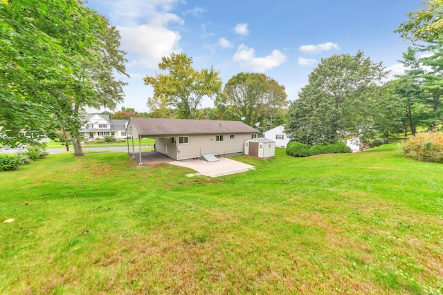 rear view of property with a yard, a shed, and a patio area