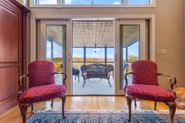 sitting room featuring a wealth of natural light and hardwood / wood-style flooring