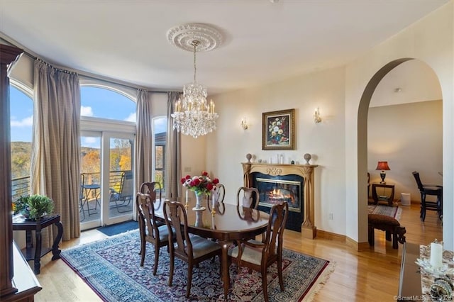 dining area featuring an inviting chandelier and light hardwood / wood-style floors