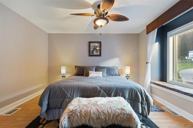 bedroom with light hardwood / wood-style flooring and ceiling fan