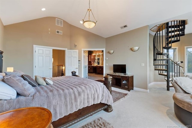 bedroom featuring connected bathroom, light carpet, and high vaulted ceiling