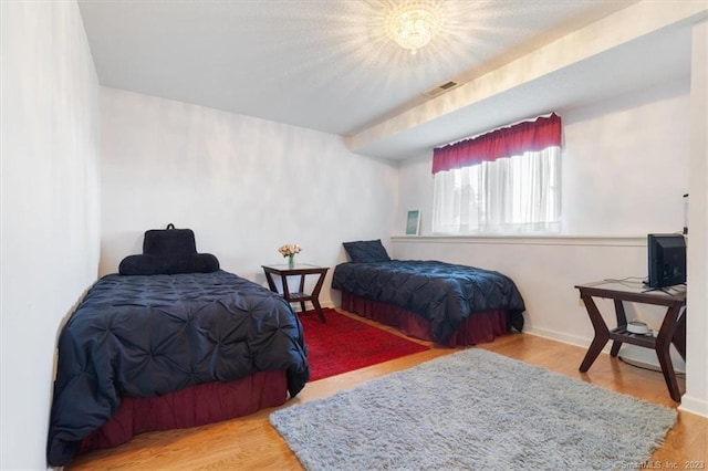 bedroom with hardwood / wood-style flooring