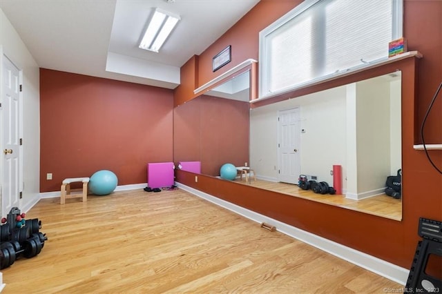 workout area with hardwood / wood-style flooring