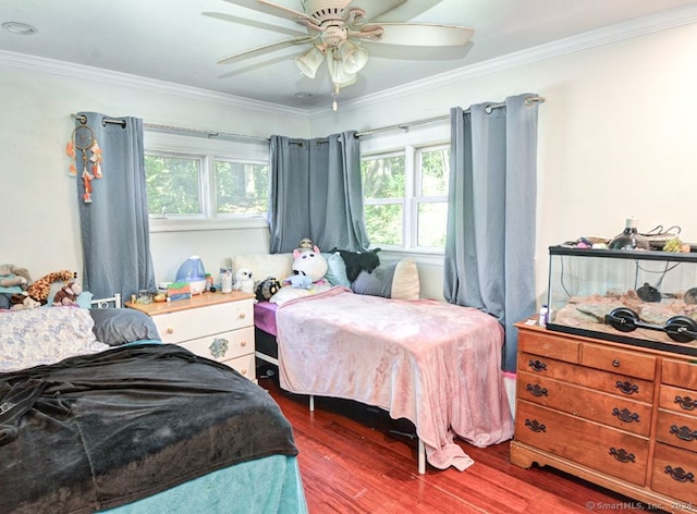 bedroom featuring ornamental molding, ceiling fan, and hardwood / wood-style floors