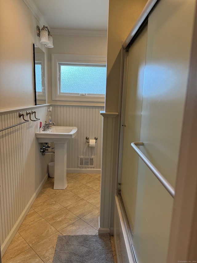 bathroom with tile patterned floors and crown molding