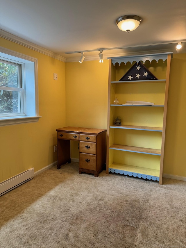 unfurnished office featuring a baseboard heating unit, ornamental molding, rail lighting, and light colored carpet