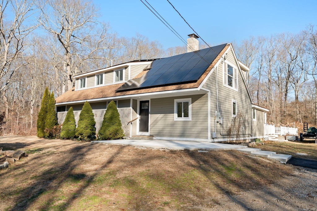 view of front of home featuring solar panels