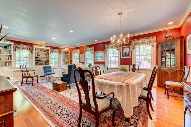 dining room featuring ornamental molding, a healthy amount of sunlight, and light hardwood / wood-style flooring