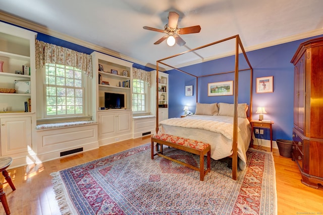 bedroom featuring light wood-type flooring, ceiling fan, and ornamental molding