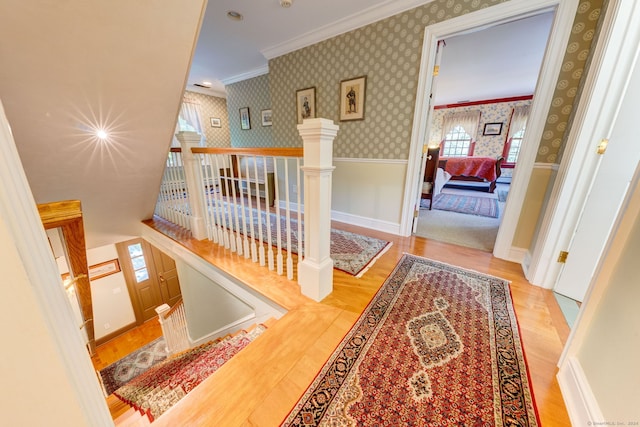 corridor featuring light hardwood / wood-style flooring and crown molding