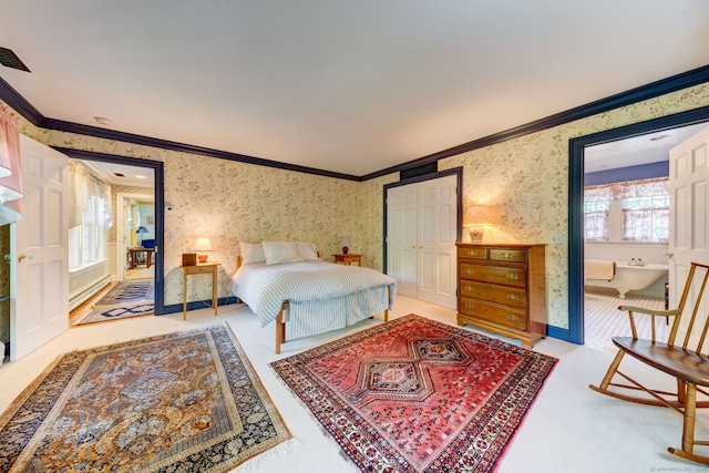 carpeted bedroom with a closet and crown molding