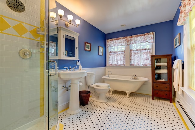 bathroom with shower with separate bathtub, a baseboard heating unit, and toilet